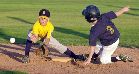 Snow Canyon's Blake Ovard steals second base while Enterprise shortstop Tanner Laub waits for the throw to make the tag during the Utah State Little League Tournament Thursday, July 13, 2001. (Photo by Jud Burkett)