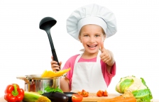 beautiful little girl with spaghetti and vegetables over white